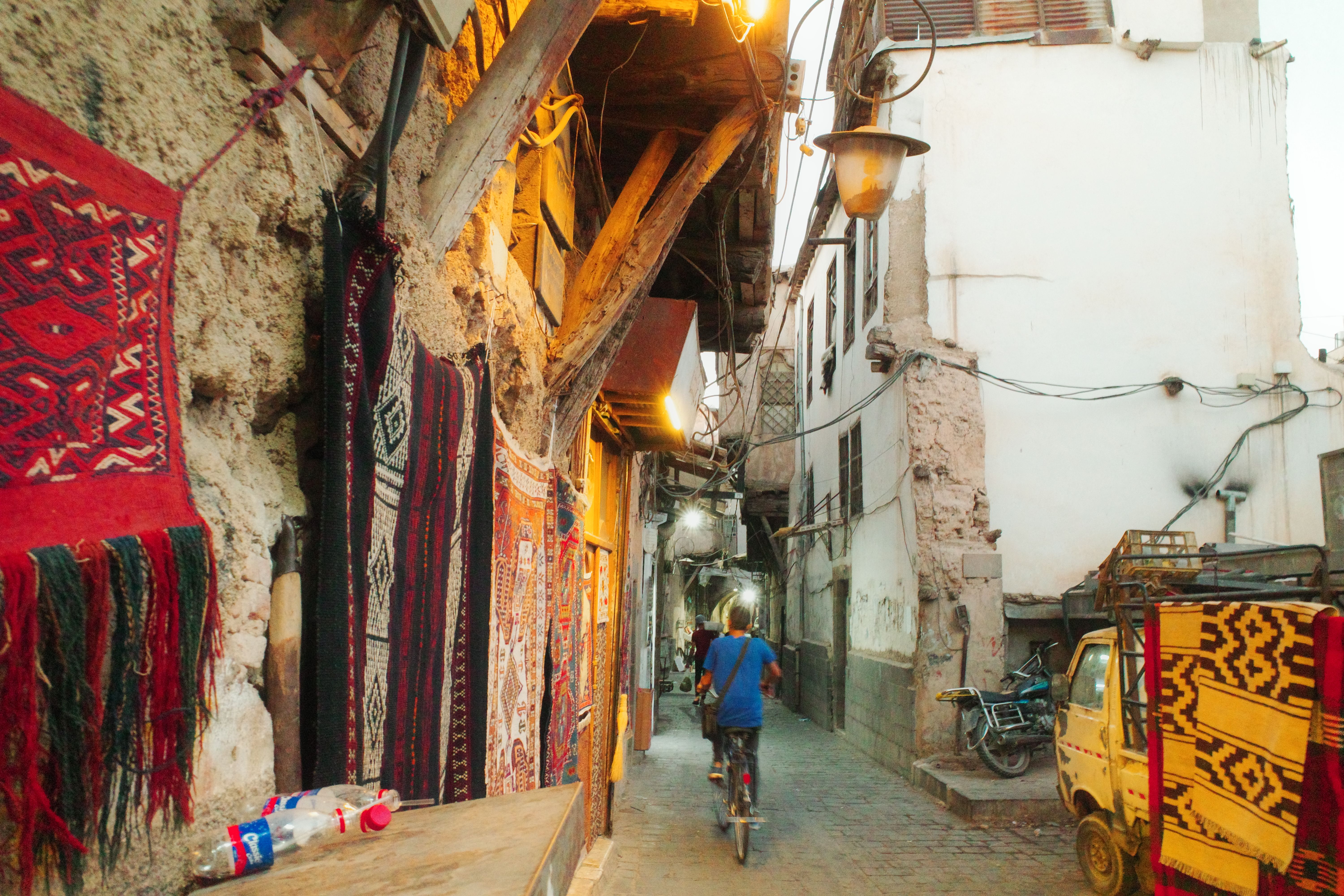 A real alley in Old Damascus lined with traditional rugs